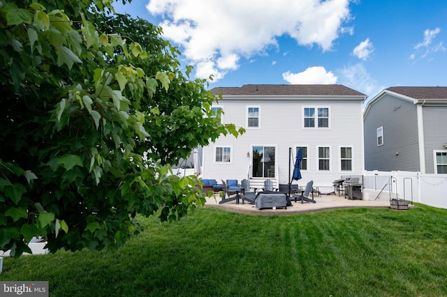 rear view of house with a patio area, outdoor lounge area, and a gate