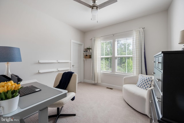 home office featuring carpet, baseboards, and a ceiling fan