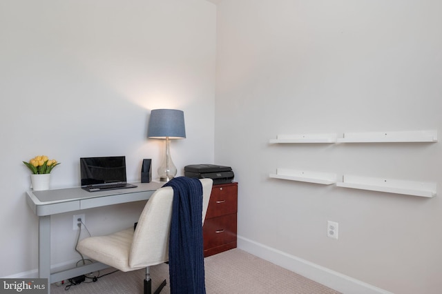 carpeted home office with baseboards
