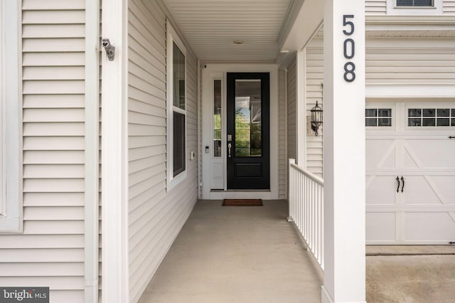view of exterior entry with a porch