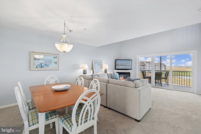 dining room with baseboards and light carpet