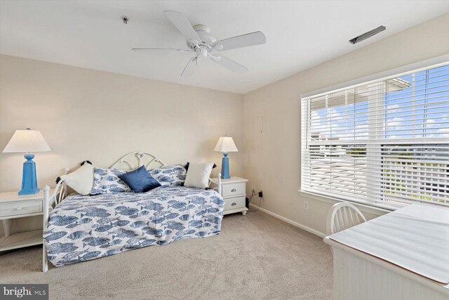 bedroom with baseboards, a ceiling fan, and carpet