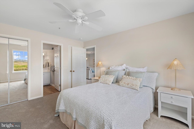 bedroom with carpet floors, baseboards, a ceiling fan, and ensuite bath