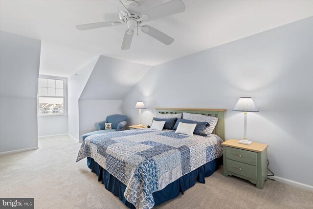 carpeted bedroom featuring baseboards, ceiling fan, and vaulted ceiling