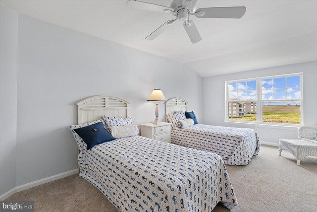 bedroom featuring carpet flooring, a ceiling fan, baseboards, and vaulted ceiling
