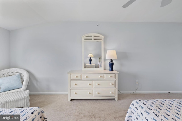 bedroom featuring light colored carpet, a ceiling fan, baseboards, and vaulted ceiling