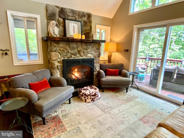 living area featuring a fireplace and lofted ceiling