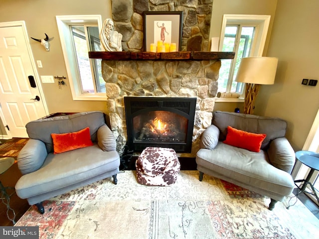 sitting room with a stone fireplace