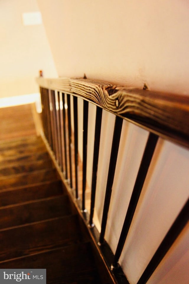 staircase with wood finished floors and baseboards