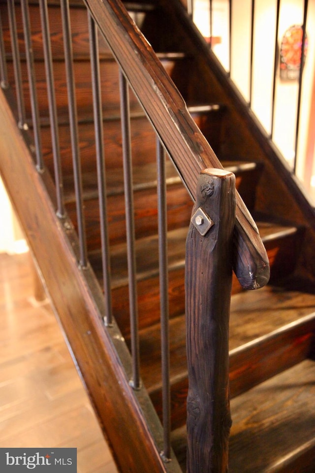 stairs featuring wood finished floors