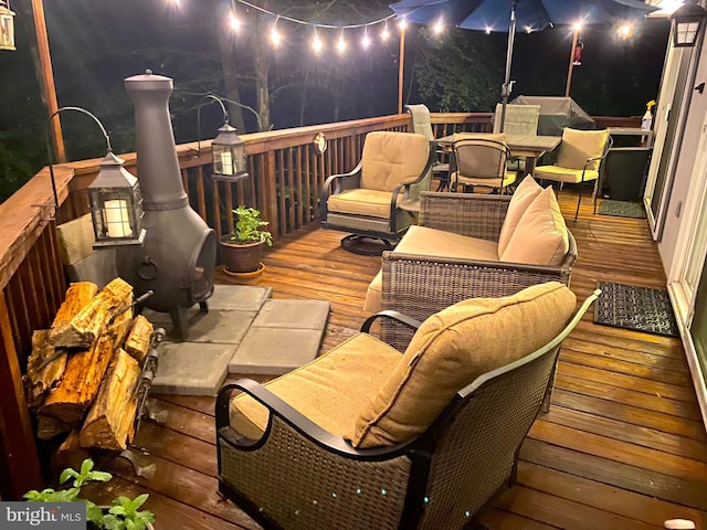 deck at night with outdoor dining area
