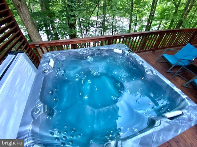 deck with an outdoor hot tub