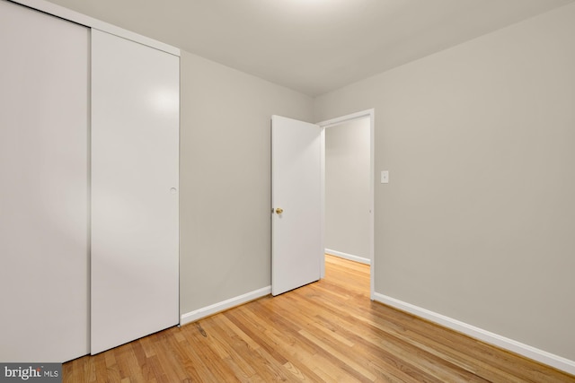 909 Snure Rd, Silver Spring, MD 20901 - unfurnished bedroom with light wood finished floors, baseboards, and a closet