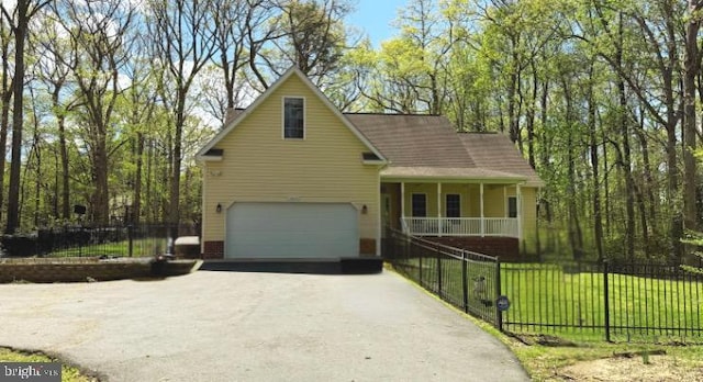 view of front of property with a porch, an attached garage, driveway, and fence private yard