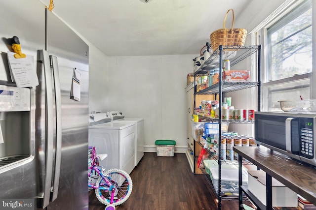 laundry area featuring washing machine and dryer, wood finished floors, and laundry area