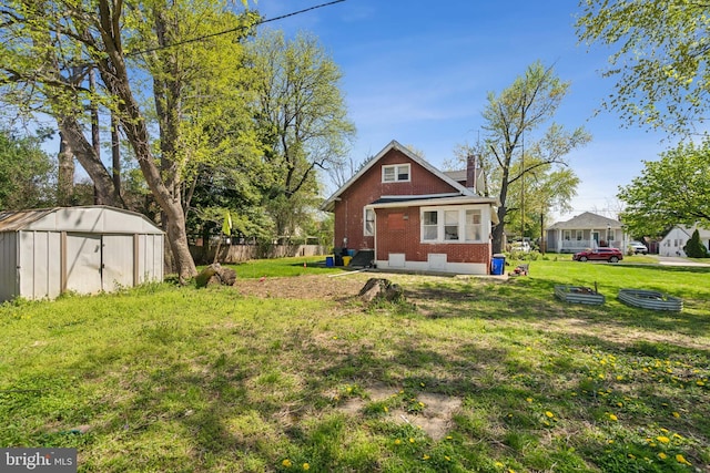 view of yard featuring fence, an outdoor structure, and a storage shed