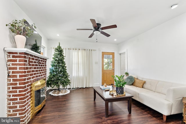 living room featuring wood finished floors, ceiling fan, recessed lighting, and a brick fireplace