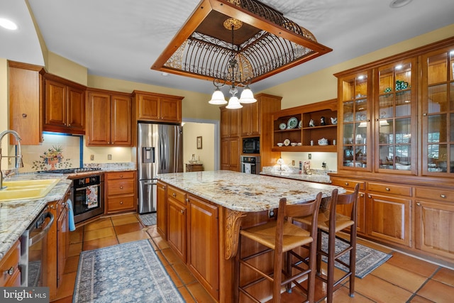 474 Gid Brown Hollow Rd, Washington, VA 22747 - kitchen featuring appliances with stainless steel finishes, a sink, a kitchen island, brown cabinetry, and light stone counters