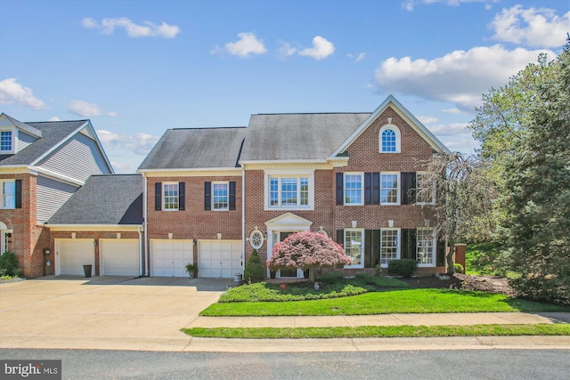 view of front of property featuring a garage, brick siding, driveway, and roof with shingles