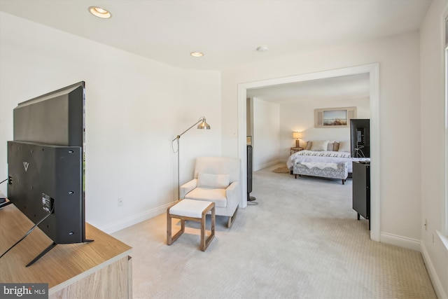 living area featuring light colored carpet, recessed lighting, and baseboards