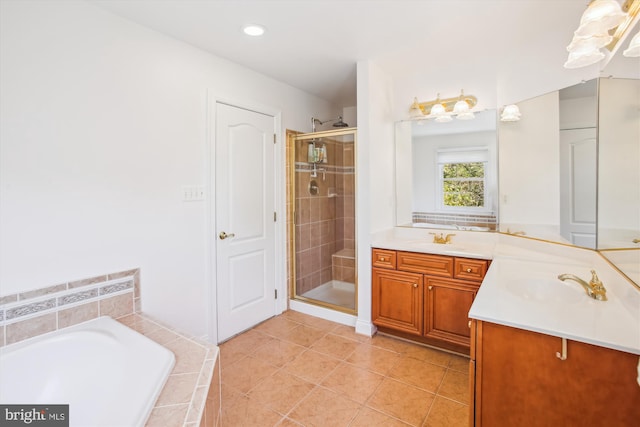 bathroom featuring vanity, a bath, tile patterned flooring, and a stall shower