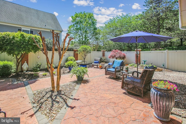 view of patio featuring an outdoor living space and a fenced backyard