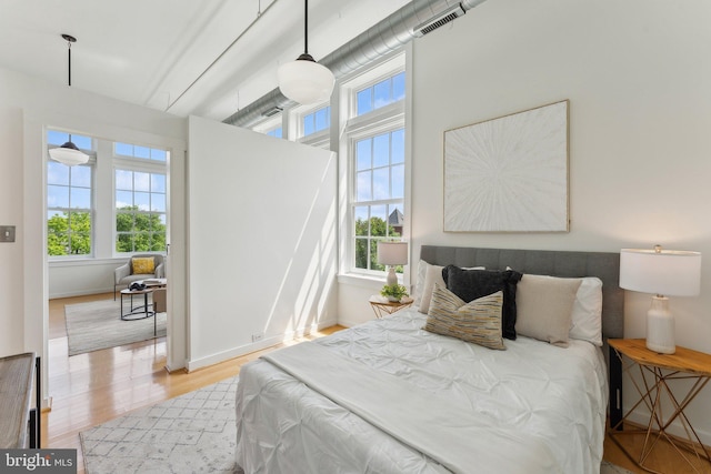 bedroom featuring light wood-style flooring and baseboards
