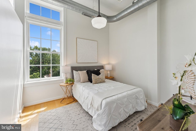 bedroom featuring baseboards and wood finished floors
