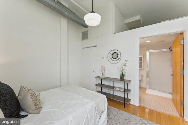 bedroom featuring wood finished floors and baseboards