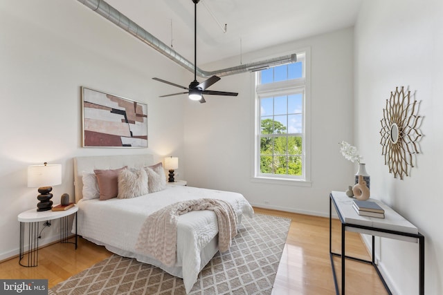 bedroom with light wood-style flooring and baseboards