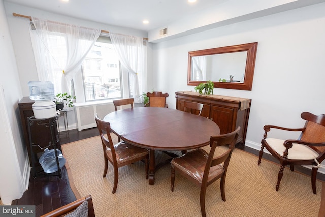 dining area featuring radiator heating unit, recessed lighting, baseboards, wood finished floors, and visible vents