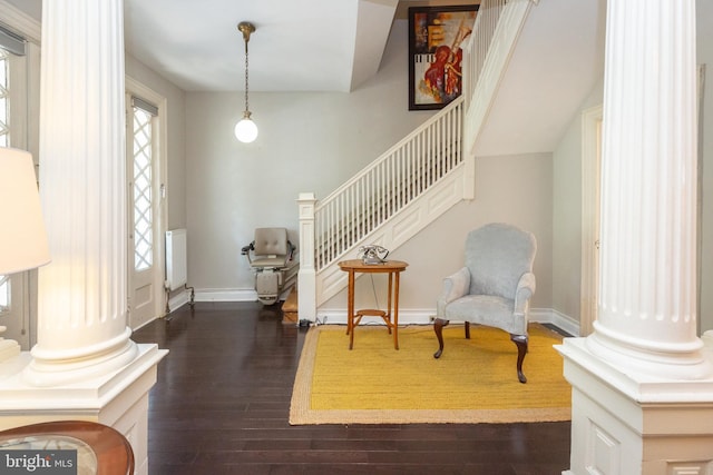 sitting room with stairs, baseboards, and dark wood-type flooring