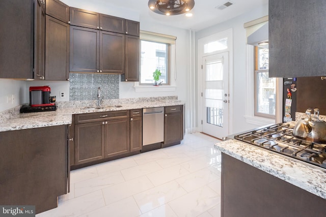 kitchen with dark brown cabinets, appliances with stainless steel finishes, a sink, marble finish floor, and visible vents