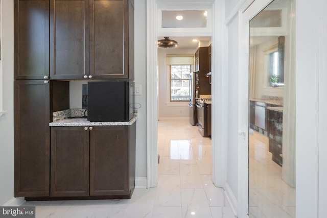 interior space with baseboards and marble finish floor