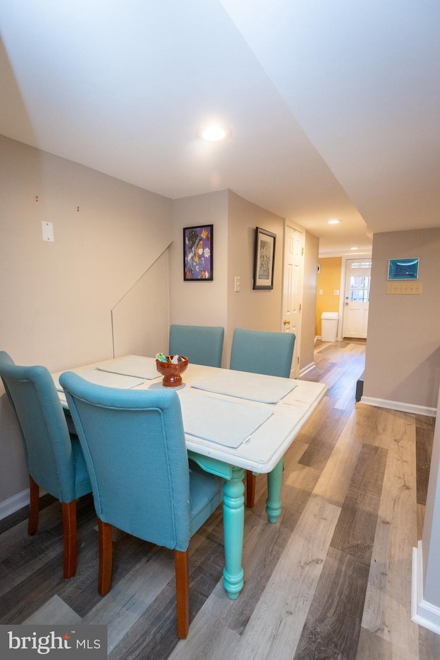dining area with baseboards, recessed lighting, and wood finished floors