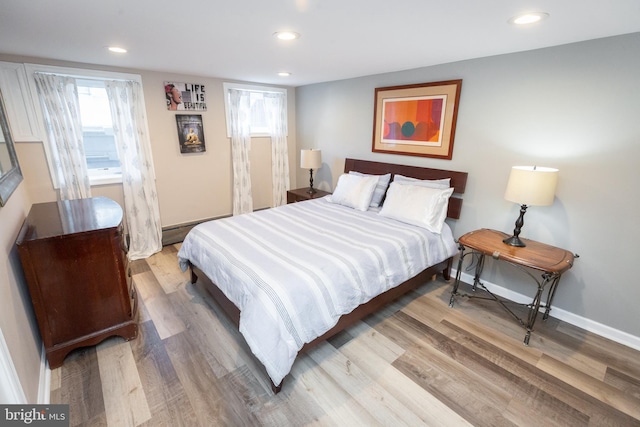 bedroom with baseboards, recessed lighting, and wood finished floors