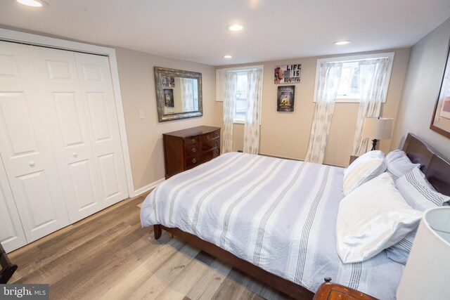 bedroom featuring a closet, recessed lighting, and wood finished floors