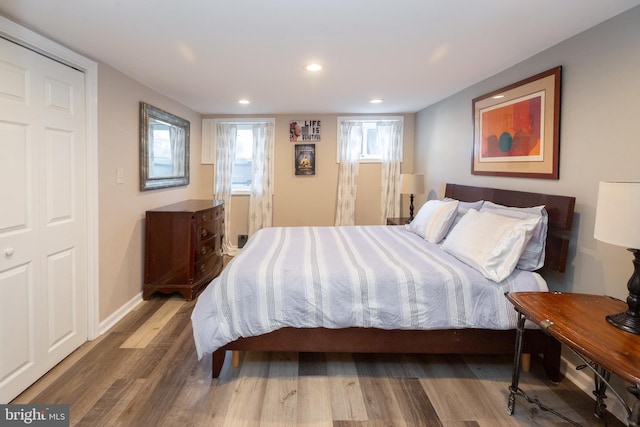 bedroom featuring baseboards, recessed lighting, and wood finished floors