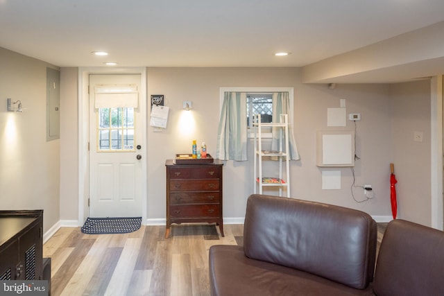 entryway featuring recessed lighting, light wood finished floors, baseboards, and electric panel