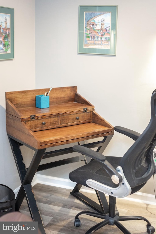 office area featuring baseboards and wood finished floors
