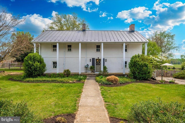 15539 Liberty Rd, Mount Airy, MD 21771 - view of front facade featuring a standing seam roof, fence, a front yard, and a chimney