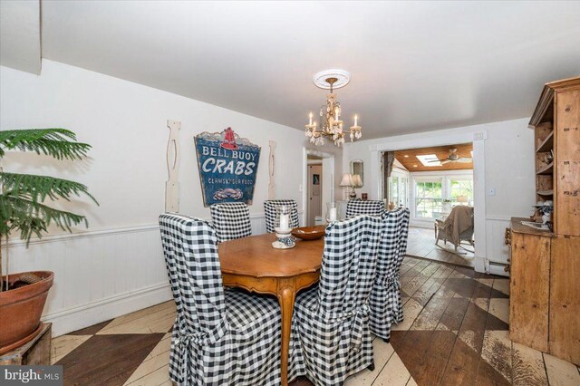 15539 Liberty Rd, Mount Airy, MD 21771 - dining space featuring wood-type flooring, a wainscoted wall, baseboard heating, and ceiling fan with notable chandelier