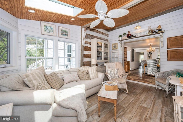 15539 Liberty Rd, Mount Airy, MD 21771 - living area featuring wooden ceiling, a skylight, wood walls, ceiling fan with notable chandelier, and wood-type flooring