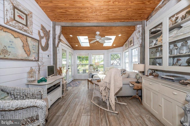 15539 Liberty Rd, Mount Airy, MD 21771 - interior space featuring wood walls, light wood-style floors, vaulted ceiling with skylight, and wooden ceiling