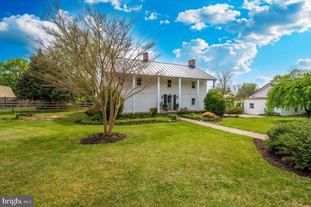 15539 Liberty Rd, Mount Airy, MD 21771 - view of front of property featuring a standing seam roof, a front lawn, metal roof, a chimney, and fence
