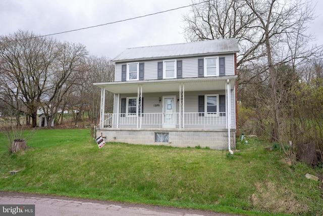 colonial-style house with a front lawn, covered porch, and metal roof