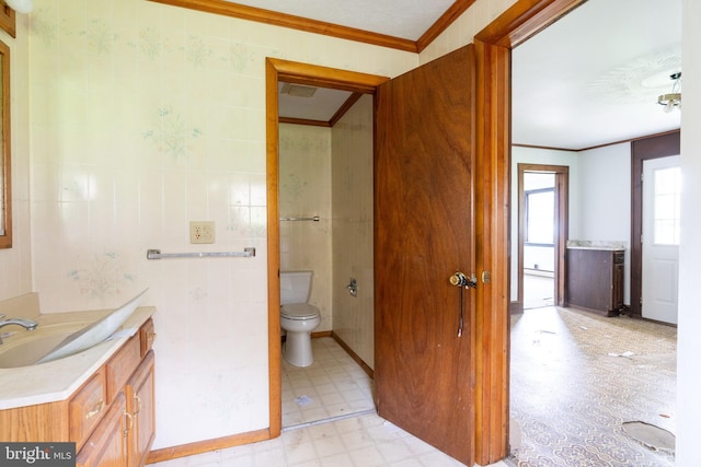 bathroom featuring tile patterned floors, vanity, ornamental molding, and toilet