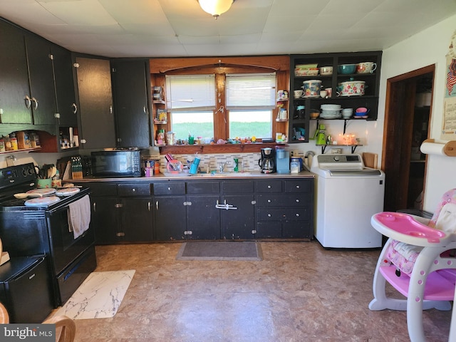 kitchen with dark cabinets, light floors, washer / clothes dryer, open shelves, and black appliances