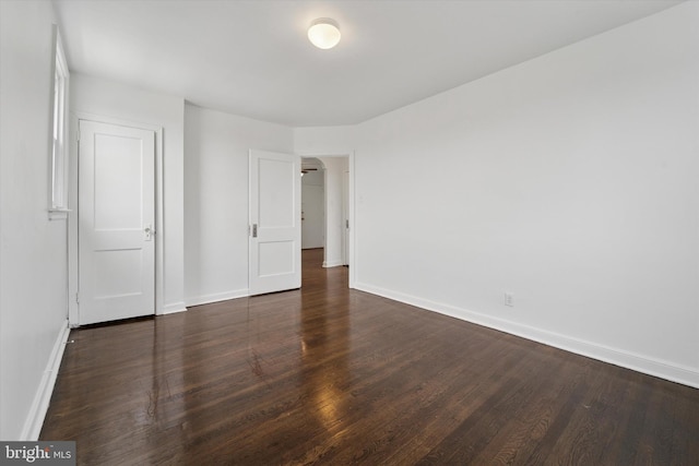 unfurnished bedroom featuring baseboards and wood finished floors