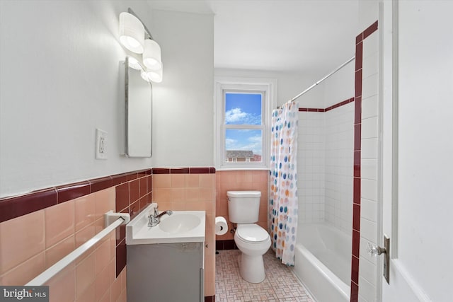 full bathroom featuring vanity, tile walls, shower / bath combination with curtain, toilet, and tile patterned flooring